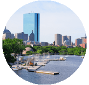 A view of the boston skyline from across the water.